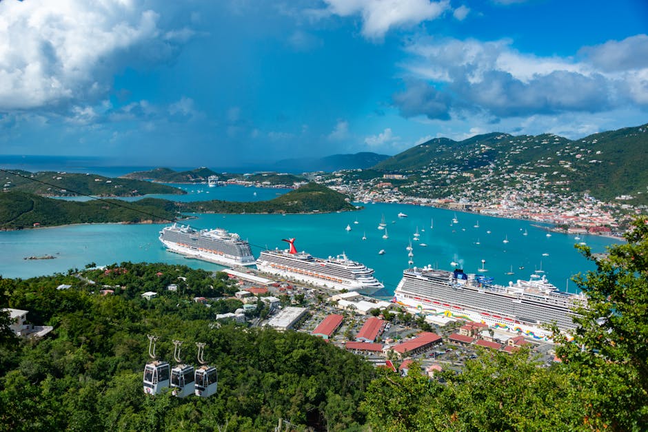 Aerial view of cruise ships docked in Charlotte Amalie Bay, Virgin Islands, under blue skies.