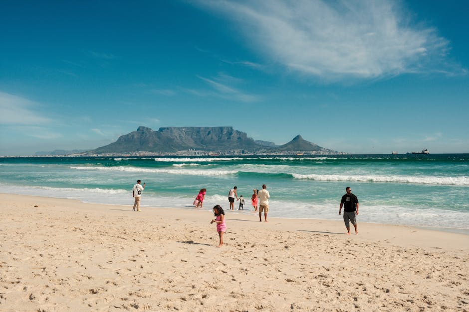 Families playing on Blouberg Beach with a stunning view of Table Mountain in Cape Town.