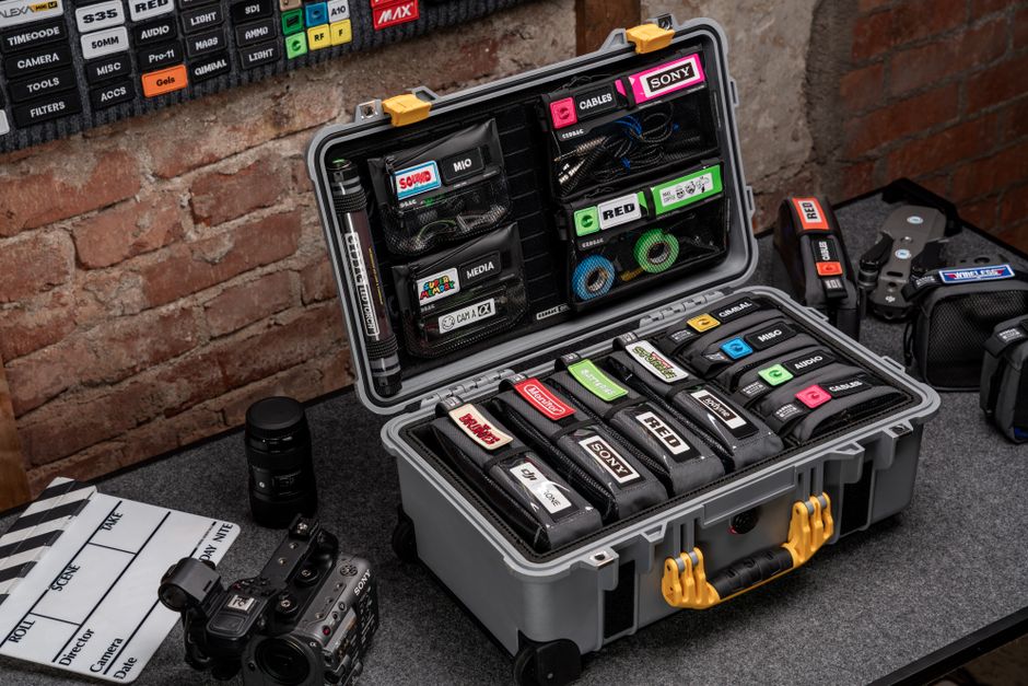 Organized camera gear in a hard case with accessories on display, perfect for photography enthusiasts.