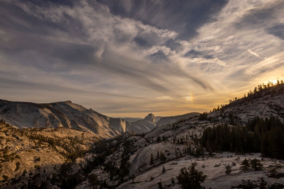 Breathtaking view of Yosemite's mountain landscape at sunset with dramatic skies.